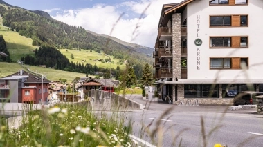 Flower meadow in front of the hotel building and view of the beautiful natural surroundings