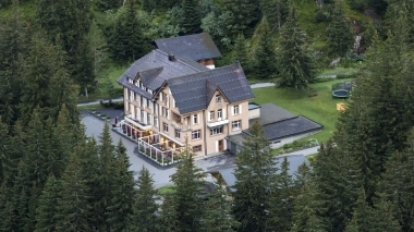 A hotel building surrounded by trees