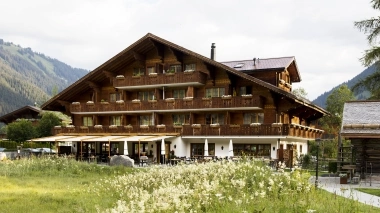 Chalet Hotel Alpenland in front of a flower meadow