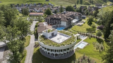 Aerial view of the Hof Weissbad surrounded by green meadows