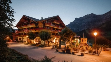 Aussenansicht vom Hotel bei Abendstimmung mit Bergen im Hintergrund