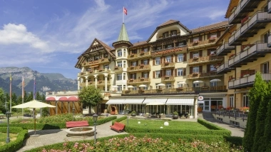 Exterior view of the hotel with gardens in the foreground