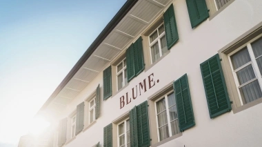 Aussenansicht des Hotels mit grünen Fensterläden