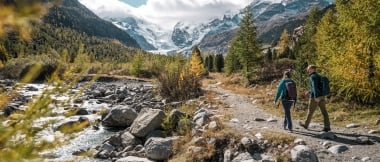 Hiking couple on their way to the Morteratsch Glacier at the Bernina Pass