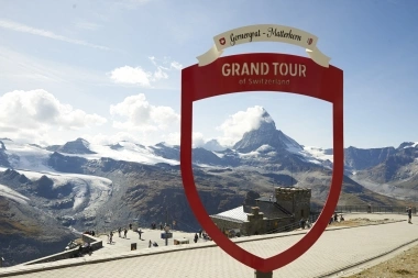 A viewing platform at Gornergrat overlooking the Matterhorn with a red Grand Tour frame in the foreground.