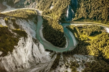 Aerial view of a river flowing through a wooded canyon.