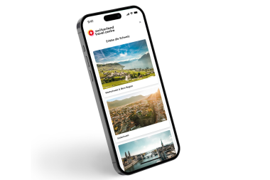 Smartphone affichant une application de voyage avec des images de la Suisse.