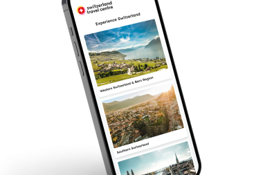 Smartphone shows a travel app with pictures of Switzerland.
