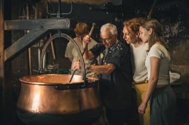 A man demonstrates how Emmental cheese was traditionally made at the Emmental Show Dairy.